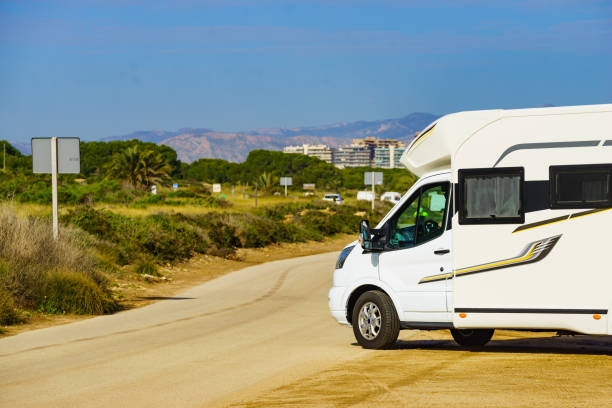 Caravan camping on mediterranean coast. Caravan wild camping on mediterranean coast of Spain. Holidays, traveling with motorhome. RV truck stock pictures, royalty-free photos & images