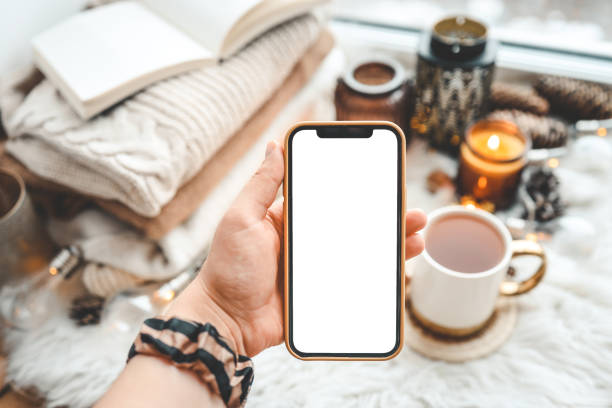 istock Phone in hands with isolated place for text in Christmas atmosphere 1443953886