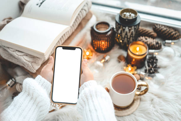 istock Phone in hands with isolated place for text in Christmas atmosphere 1443953911