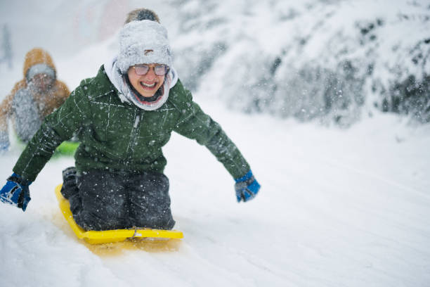 istock Mother and three kids sledding during the blizzard 1443953952
