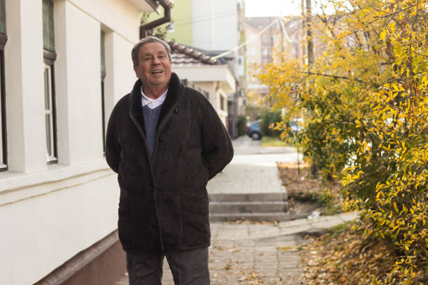 istock Cheerful senior man in front of house 1443957088
