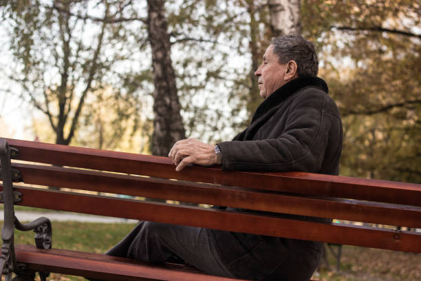 istock Lonely senior man sitting on bench 1443957157
