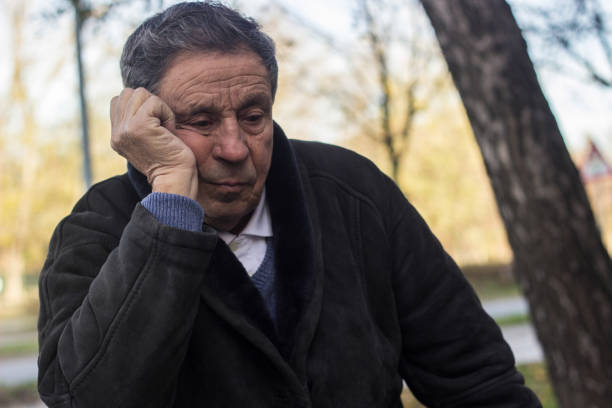 istock Lonely senior man sitting on bench 1443957188