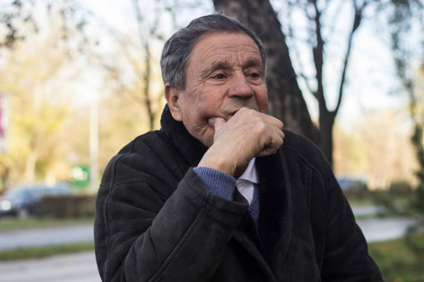 istock Lonely senior man sitting on bench 1443957242