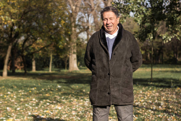 istock A smiling and satisfied elderly man walking through the park 1443957258