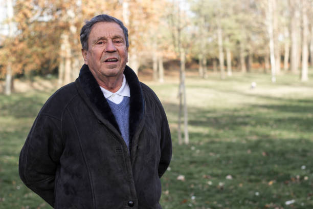 istock A smiling and satisfied elderly man walking through the park 1443957362
