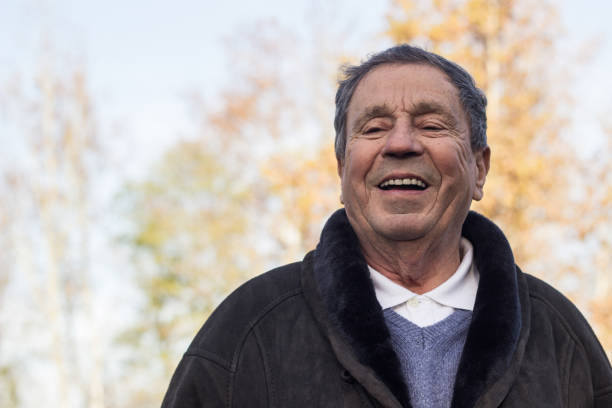 istock A smiling and satisfied elderly man walking through the park 1443957363