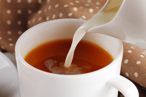 istock Coffee with milk. Milk is poured into the coffee. 1443957939