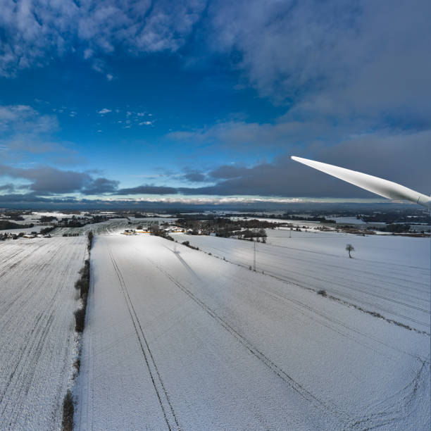 One windmill in the Dutch polder during winter. With a dramatic sky. Wide shot.