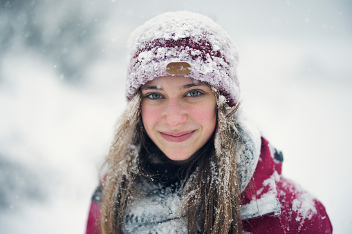 Portrait of a girl with a showel in the snow.