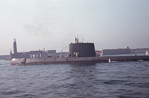 Naples, Campania, Italy, 1963. US Navy submarine 571 departs the port of Naples. Also: Sailors.