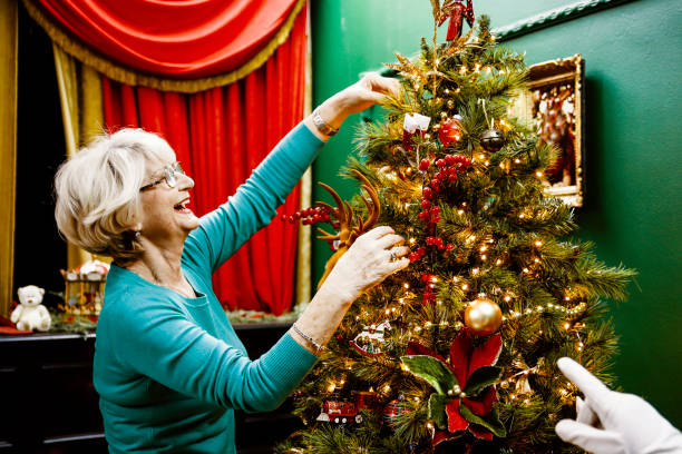 istock Grandmother decorating Christmas tree 1443969787