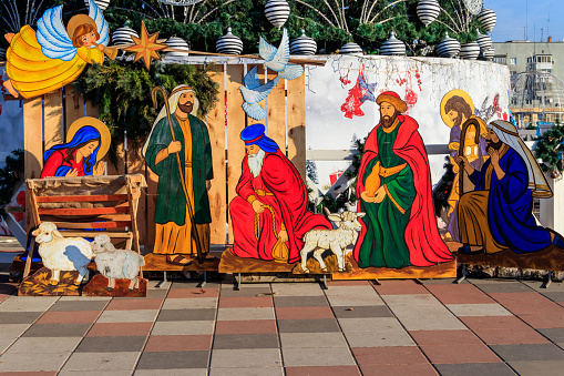 Wooden Christmas Nativity scene with Holy family in city park
