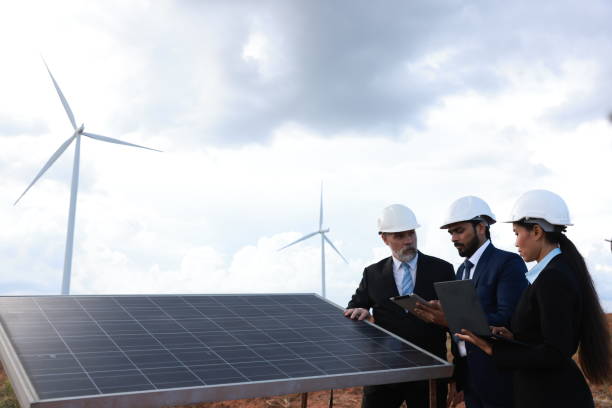 istock Senior businessman work with windmill engineer and solar engineer design green energy power supply  . Green energy and renewal energy concept, Windmill engineer and businessman work together at wind turbine farm 1443977504