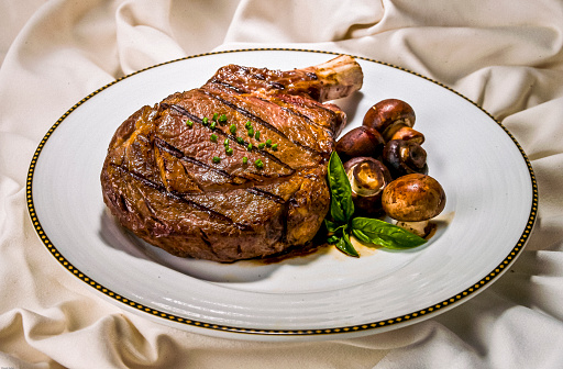 Grilled to perfection the rib eye steak and golden mushrooms make a delicious dinner.