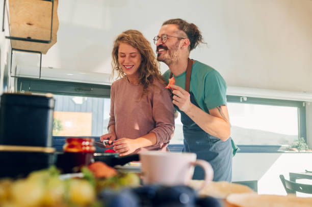 istock Young couple making breakfast together in the kitchen at home 1443981343