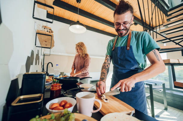 istock Young couple making breakfast together in the kitchen at home 1443981345