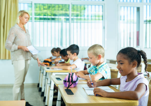 istock Group of focused kids working at class 1443985141