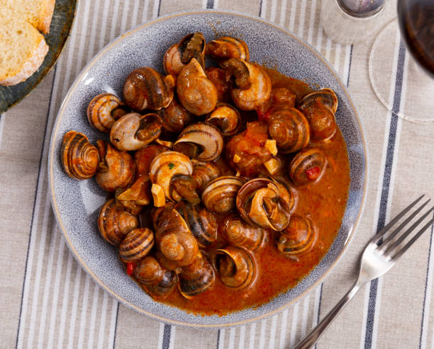 Mediterranean seafood stew of caracoles snails with vegetable sauce stock photo