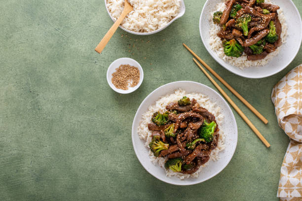 istock Beef and broccoli stir fry served over rice 1443990656