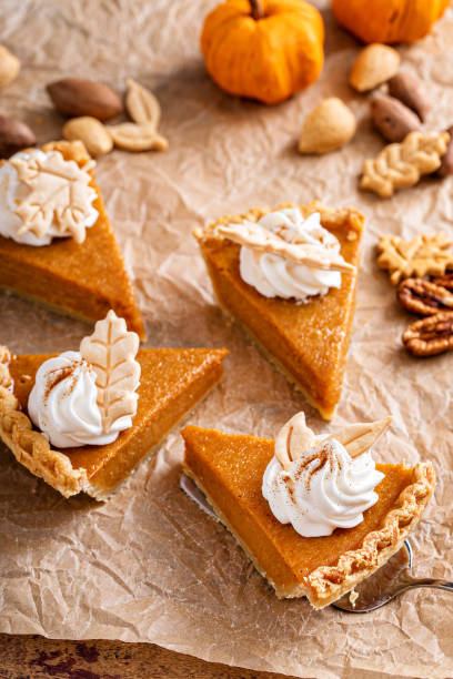 istock Festive pumpkin pie slices decorated with whipped cream 1443990749
