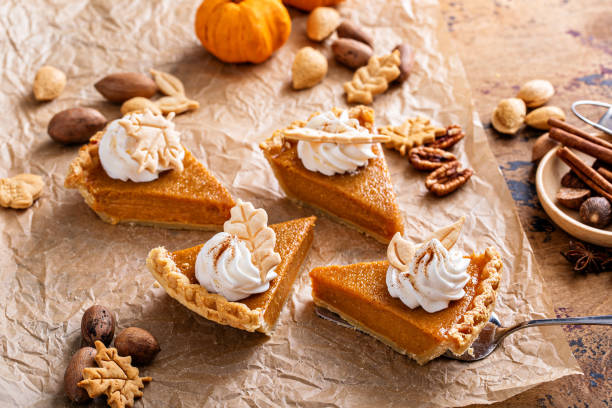 istock Festive pumpkin pie slices decorated with whipped cream 1443990755