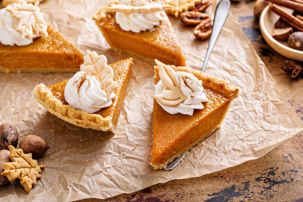 istock Festive pumpkin pie slices decorated with whipped cream 1443990759