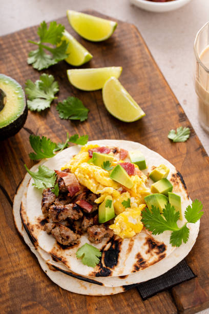 istock Breakfast tacos with sausage, eggs, bacon and avocado 1443991780