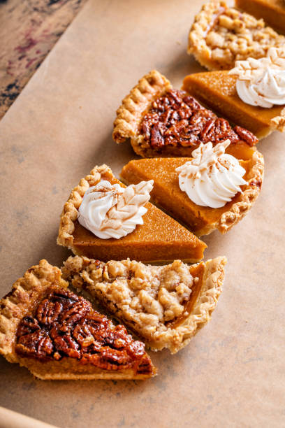 istock Traditional fall Thanksgiving pie slices, pumpkin and pecan pie 1443991910