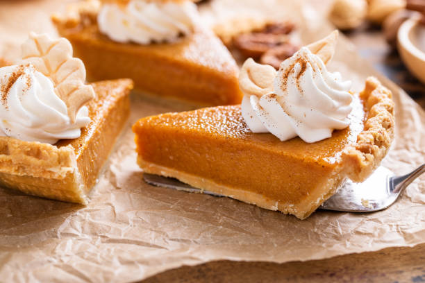 istock Festive pumpkin pie slices decorated with whipped cream 1443991918