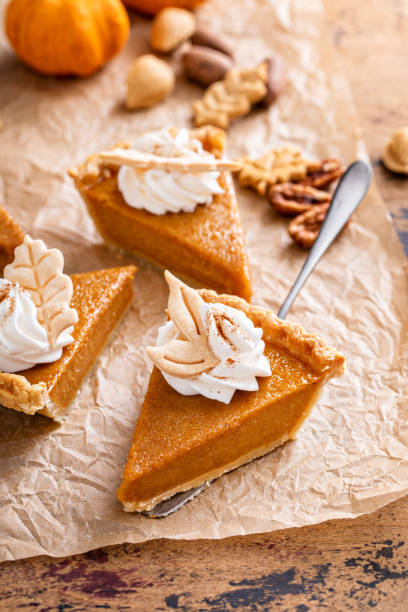 istock Festive pumpkin pie slices decorated with whipped cream 1443991932