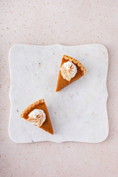 istock Pumpkin pie slices topped with whipped cream 1443991955