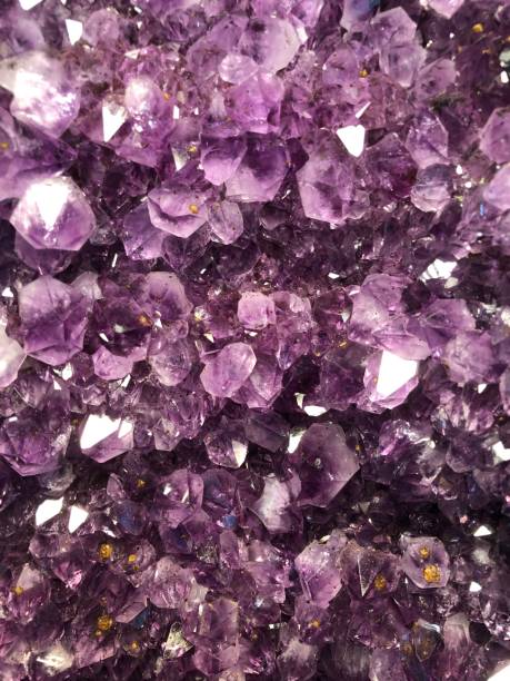 Close up of a purple amethyst crystal A purple amethyst shines and glitters natural pattern pattern nature rock stock pictures, royalty-free photos & images