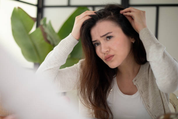 istock young woman lose hair 1443992962