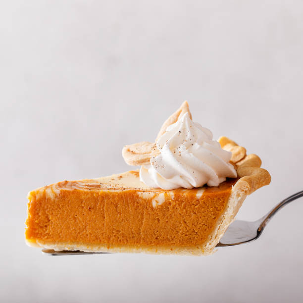 istock Pumpkin cheesecake swirl pie topped with whipped cream 1443992974