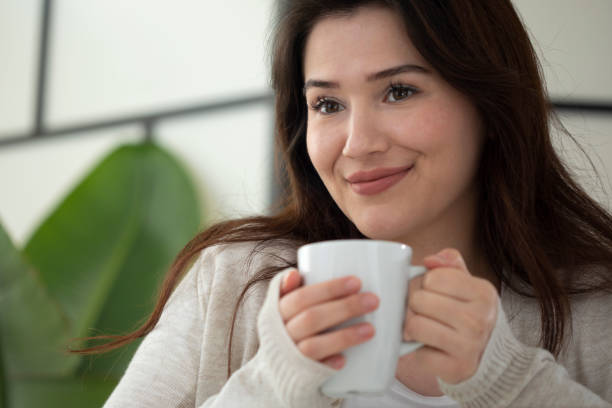 istock woman drinking cup of coffee 1443993008