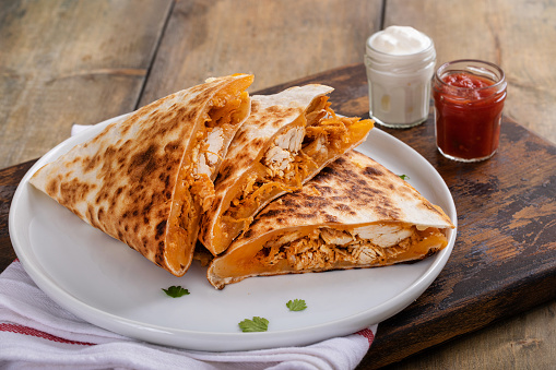 Pulled chicken and cheddar quesadillas on a plate ready to eat