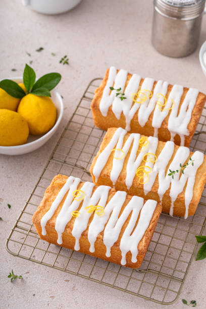 istock Classic lemon pound cake with powdered sugar glaze dripping over 1443993476