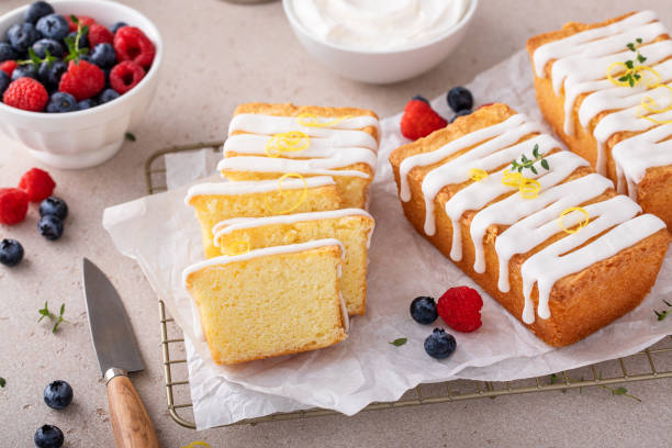 istock Classic vanilla pound cake with powdered sugar glaze sliced on parchment 1443993484