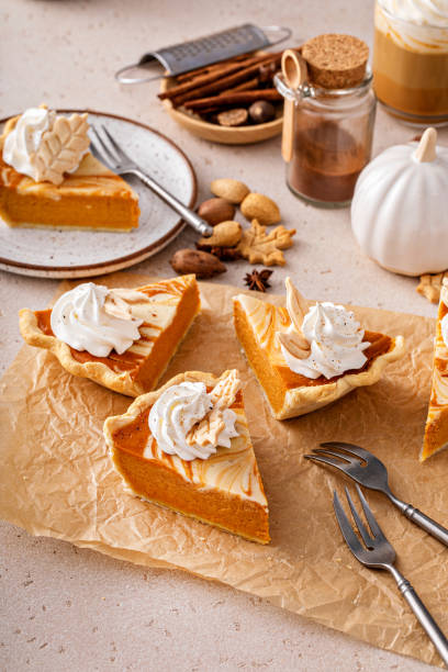 istock Pumpkin cheesecake swirl pie topped with whipped cream 1443993825
