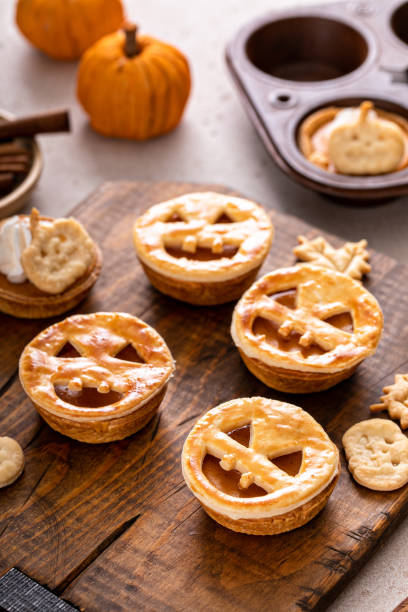 istock Halloween pumpkin pies with carved pumpkin face on top 1443993833