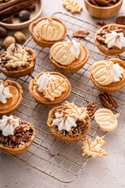 istock Mini pumpkin and pecan pies baked in muffin tin 1443993850
