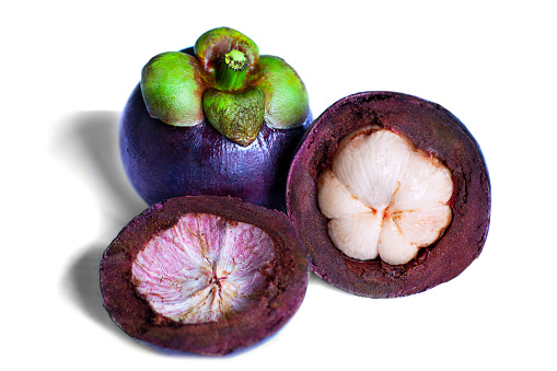 Mangosteen fruit with cut in half sliced isolated on white