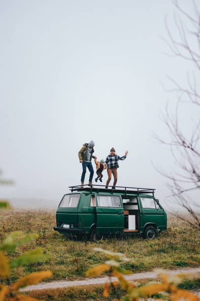 istock Cheerful Smiling Family Holding Hands And Jumping On A Van 1443997963