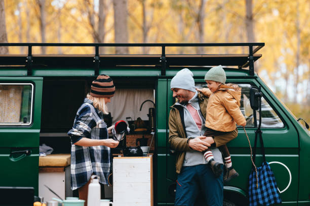 istock Happy Woman Holding Kettle And Making Tea In Her Van 1443997979