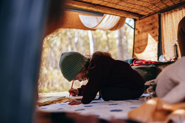 istock Cute Little Girl Drawing Something Inside A Van 1443998012