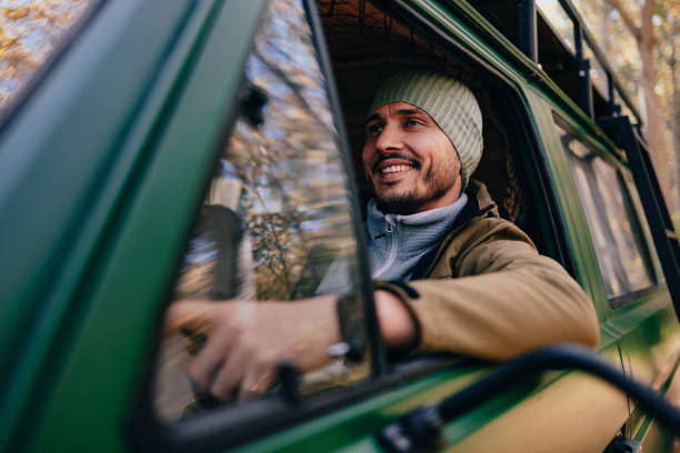 istock Smiling Man Driving His Van In The Forest 1443998093