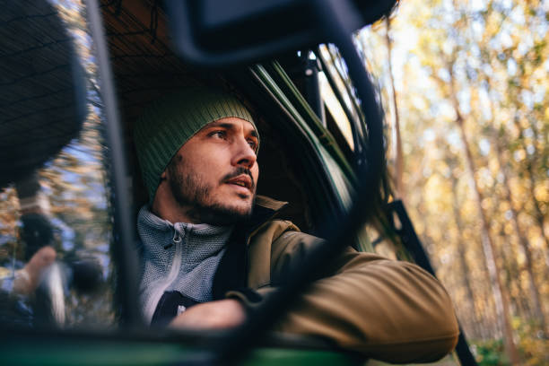 istock Serious Man Driving His Van In The Forest 1443998106