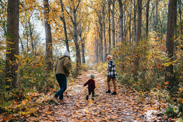 istock Back View Of Happy Family Having Fun While Exploring Nature Together 1443998115