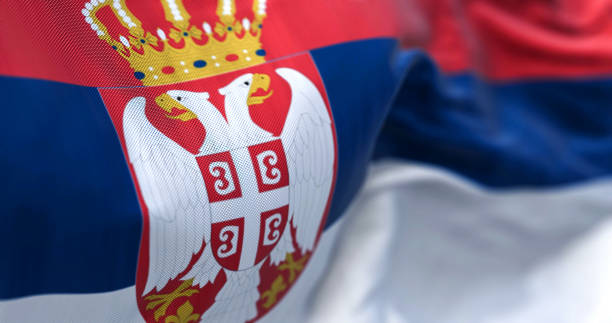 close-up view of the serbia national flag waving in the wind - bandeira da sérvia imagens e fotografias de stock